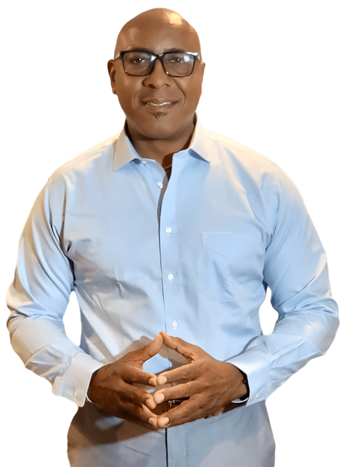 Man in blue shirt with glasses smiling.